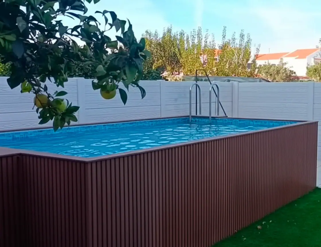 Modular concrete wall in grey concrete marking off the pool area of a house
